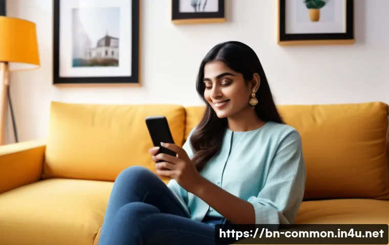 모바일 기술 - A young Bengali professional woman sitting comfortably in a modern living room, using a sleek smartp...